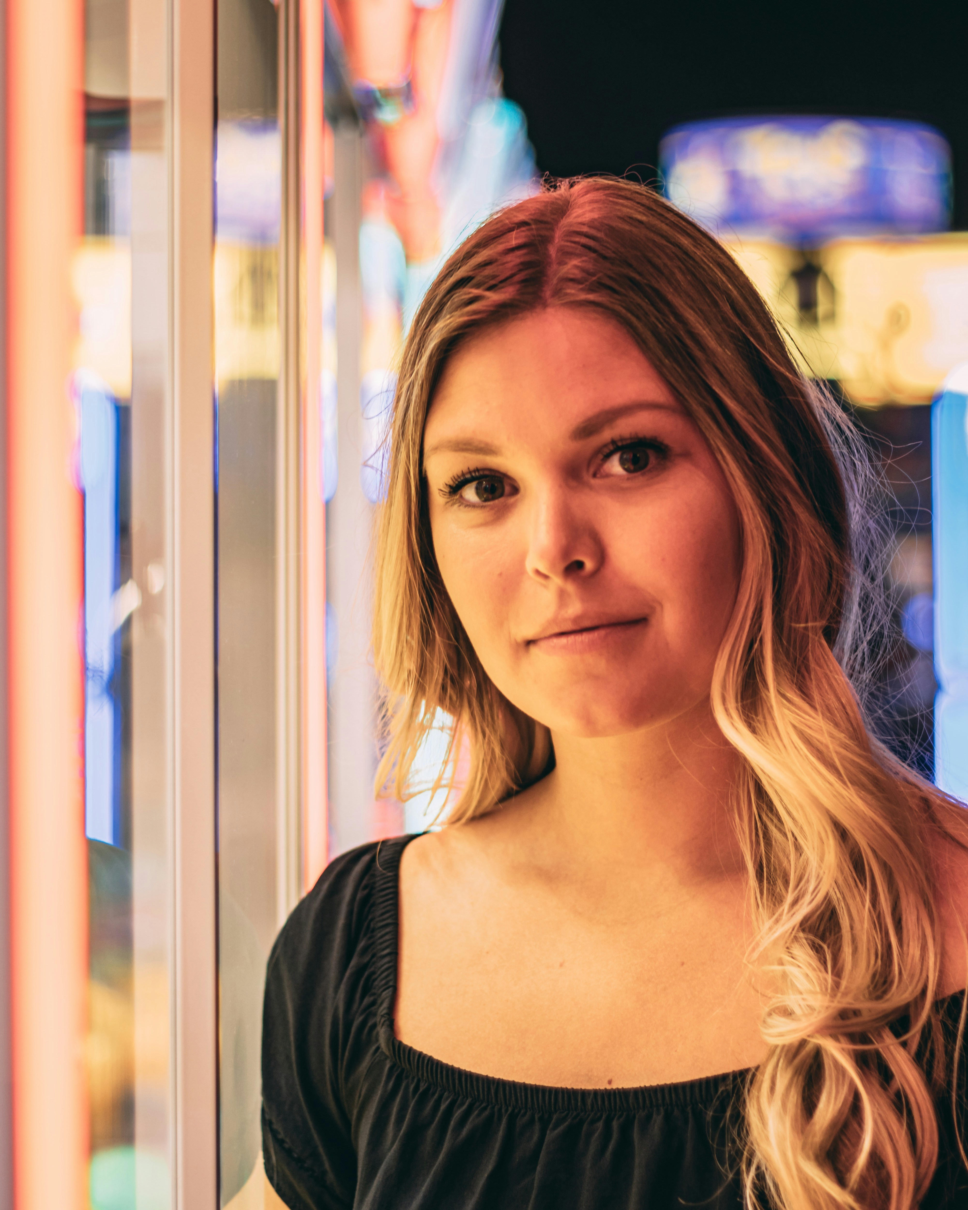 woman standing beside glass window