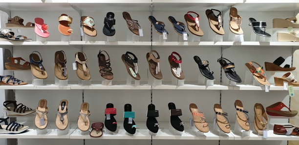 Bright, colorful display of our Sponch sandals arranged on a clean modern shelf.