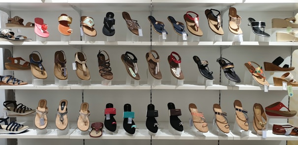 Row of colorful women's sandals neatly displayed under warm lighting in the showroom