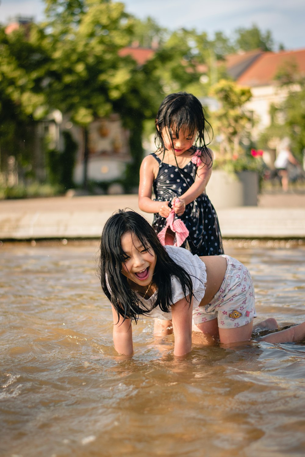 two girl swimming on body of water