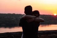 couple hugging each other during sunset