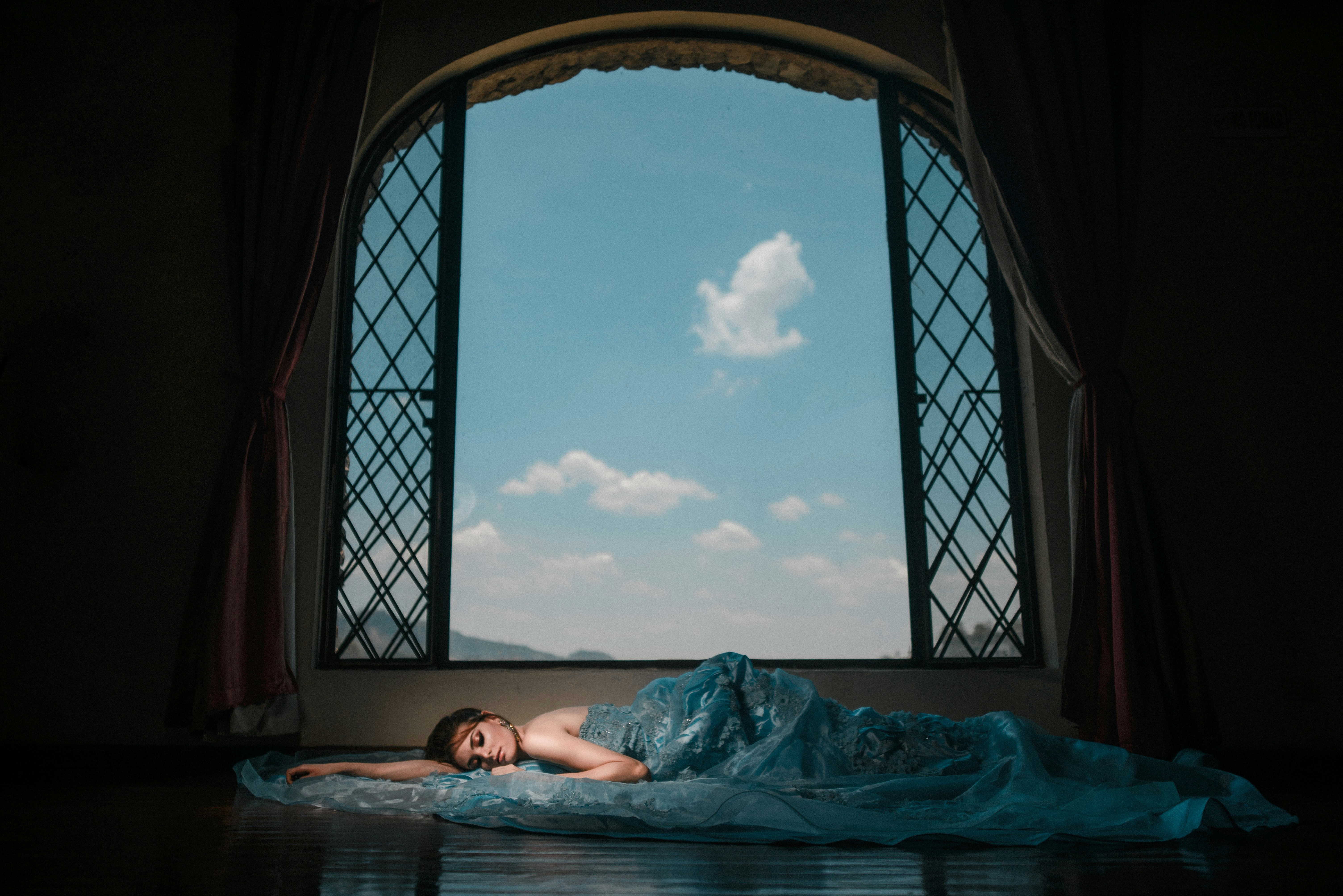 Woman lying beside window