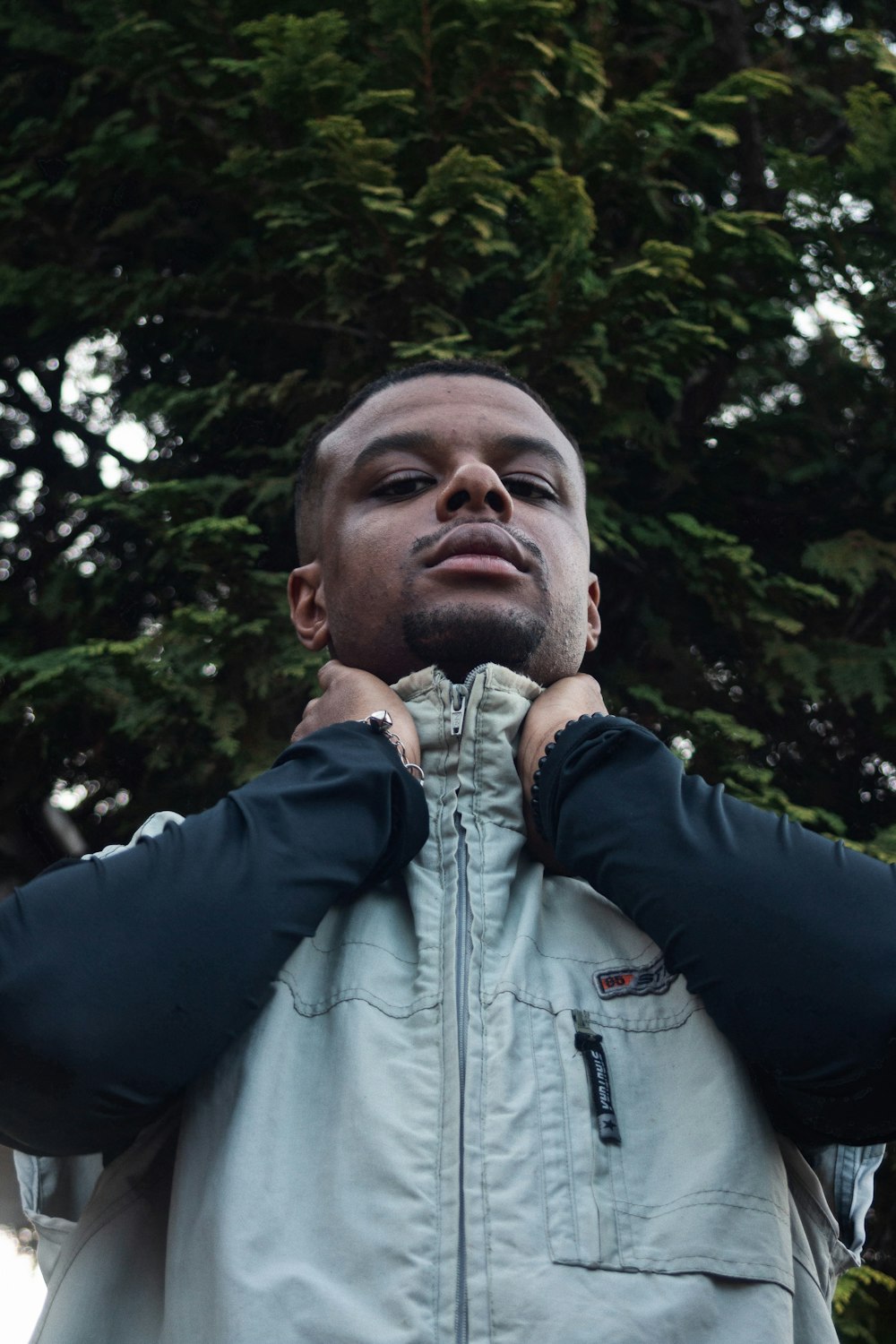 man wearing gray zip-up jacket