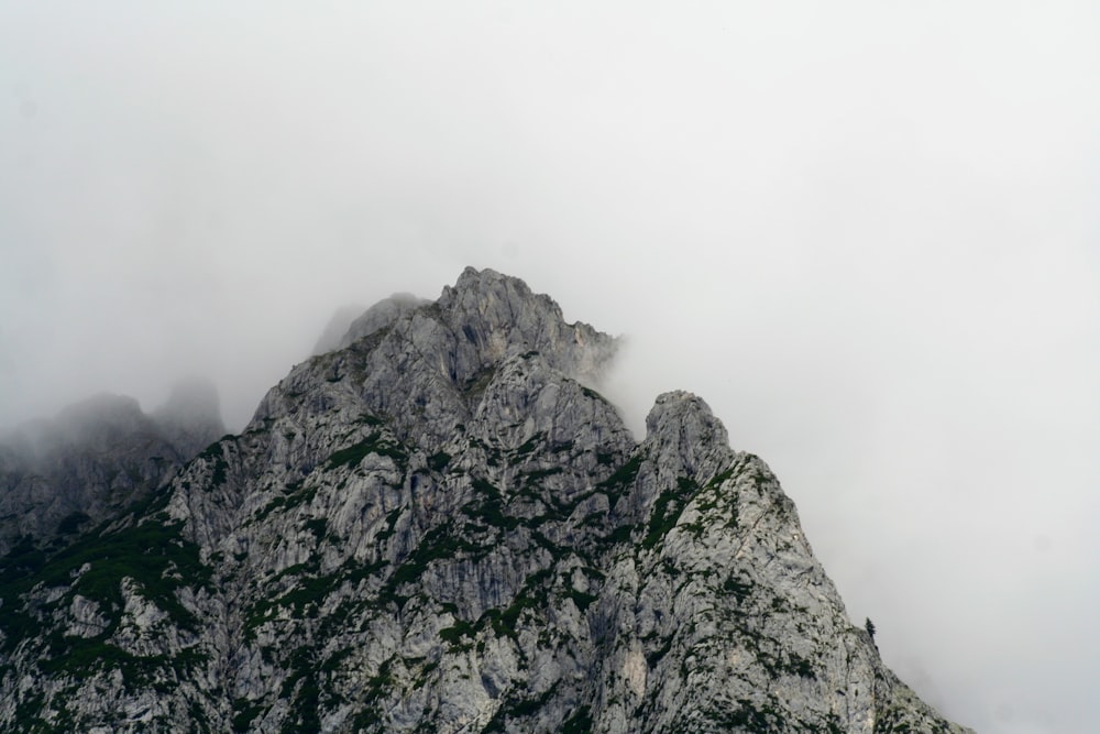 a very tall mountain covered in fog and clouds