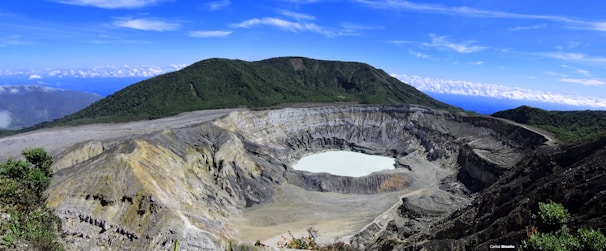 A breathtaking view of a volcanic crater surrounded by lush greenery.