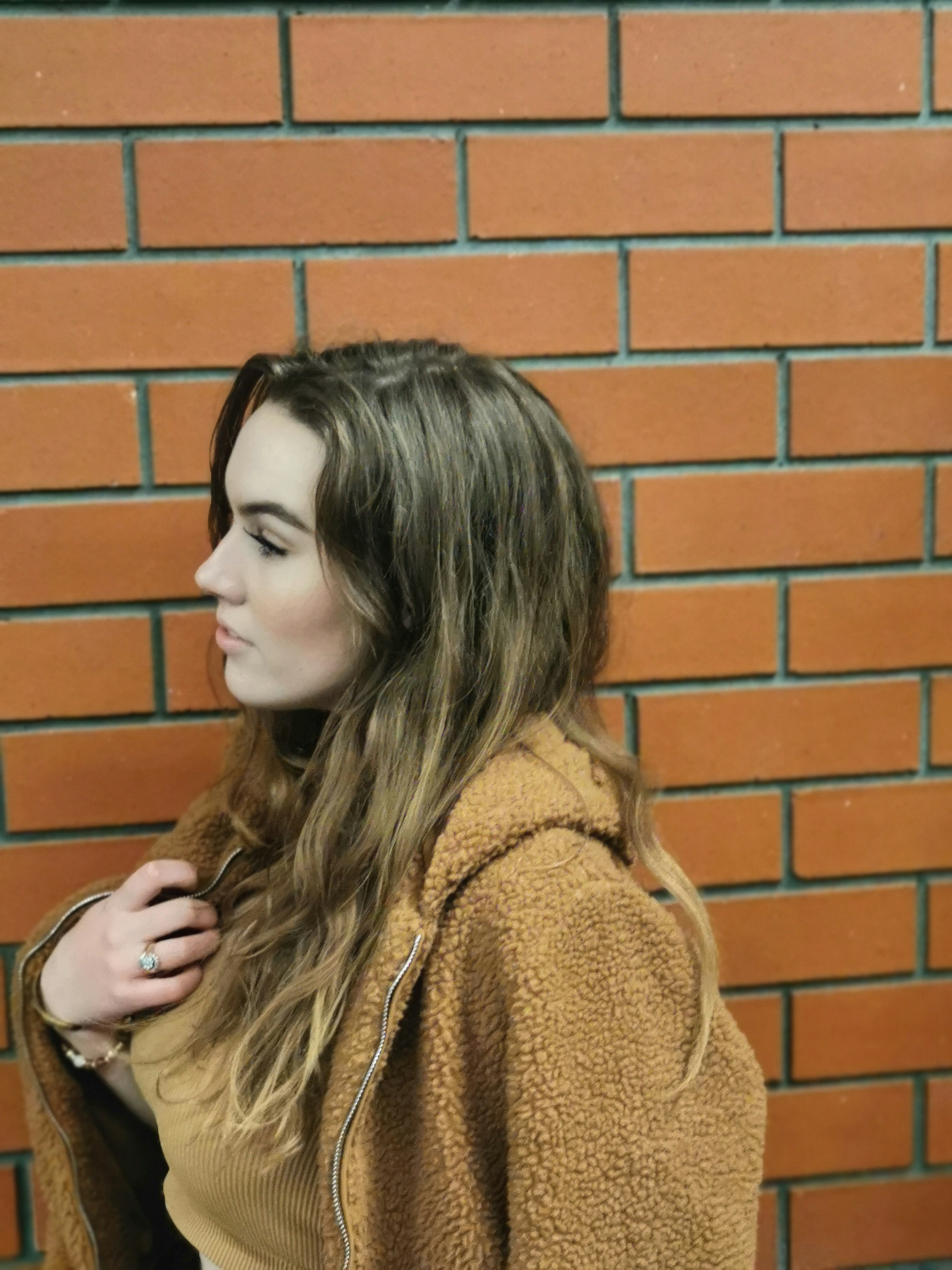 woman wearing brown jacket