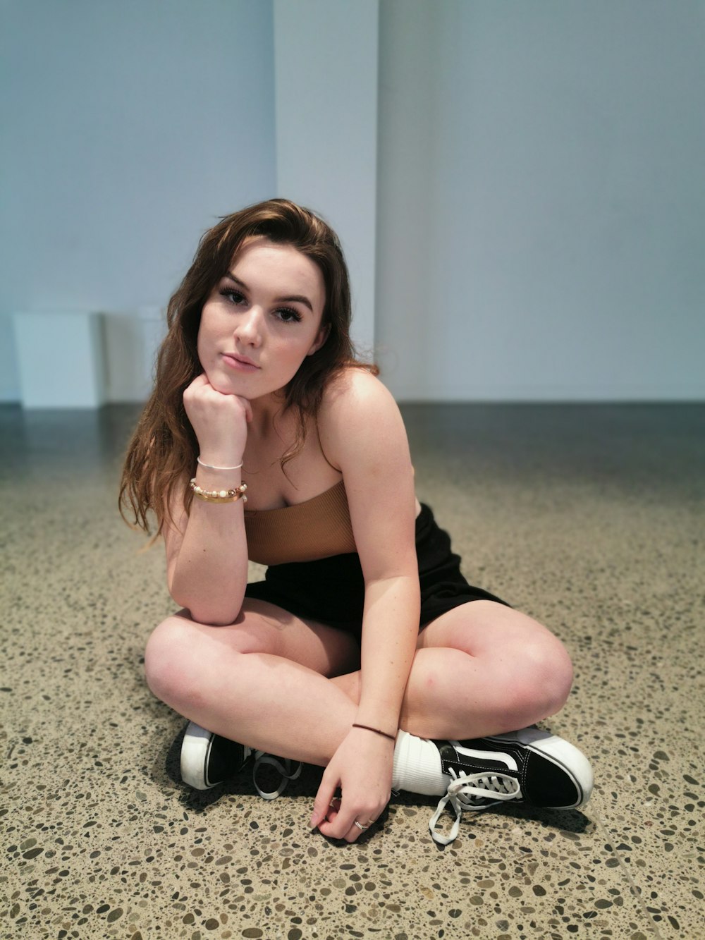 woman sitting near white wall