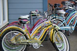 Colorful mini-cruisers lined up on a wooden floor, ready for a casual ride.