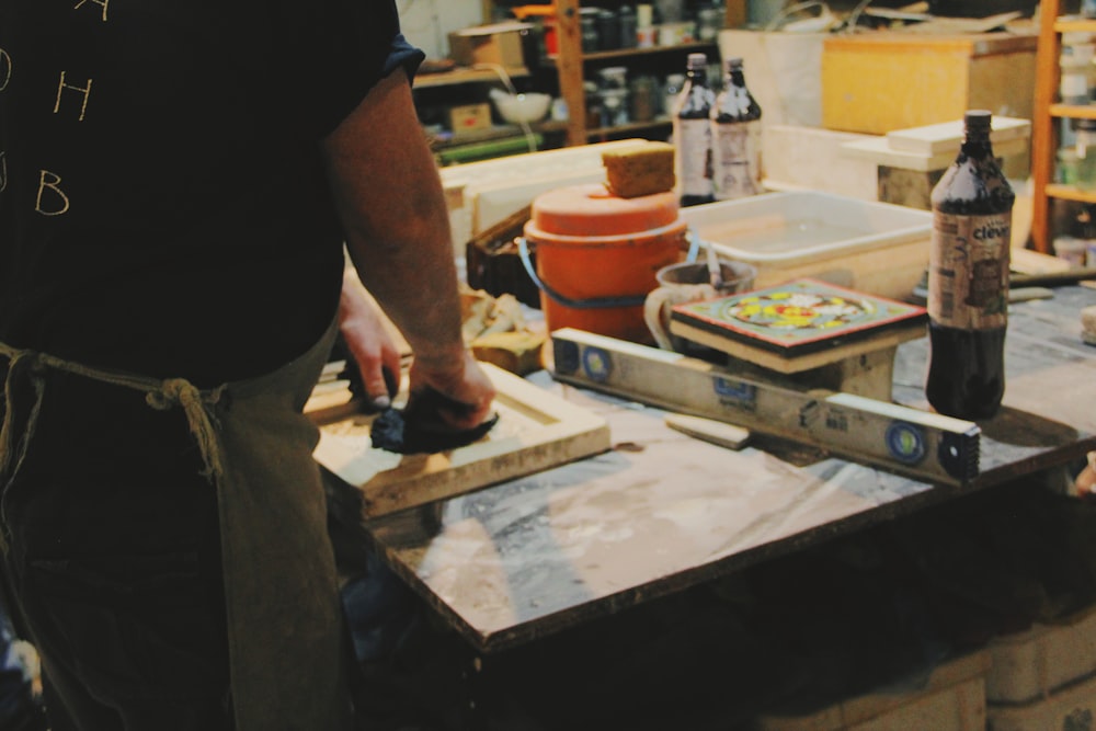 person standing in-front of table with grey spirit level