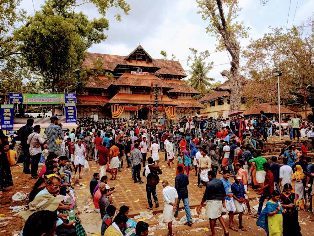 a crowd of people standing around a building