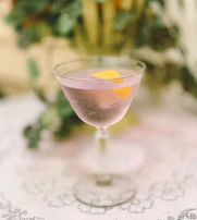 Elegant mocktail served in a vintage glass with a peach-colored accent napkin.