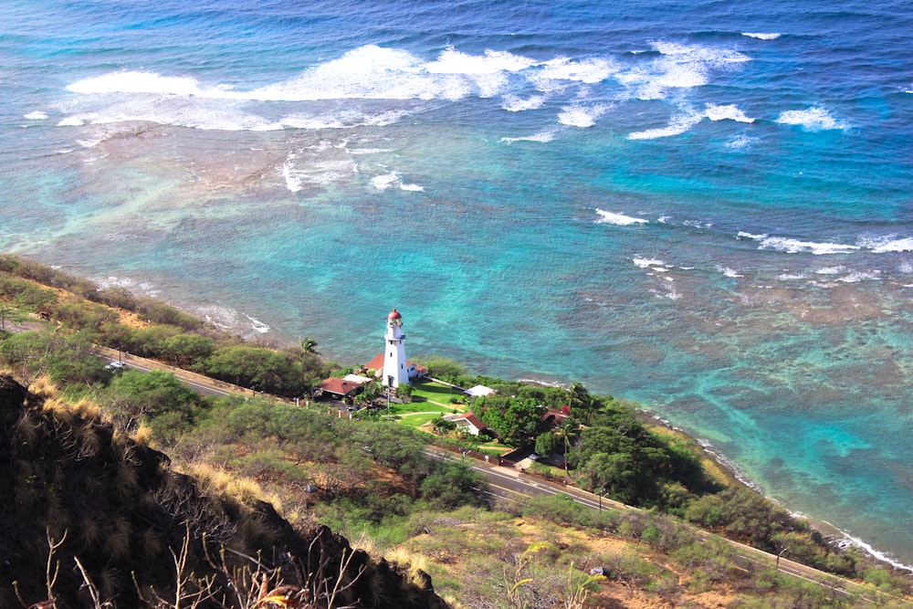 white lighthouse beside body of water