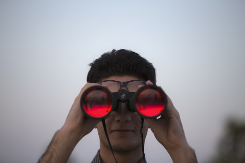 person holding black binoculars