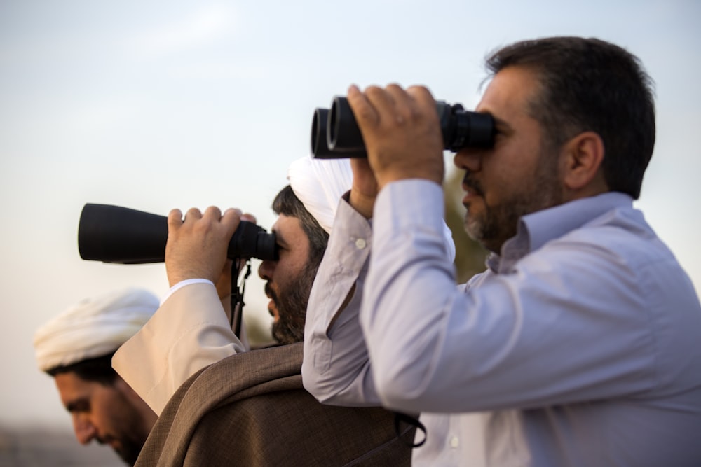 two men using binoculars