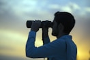 man holding telescope