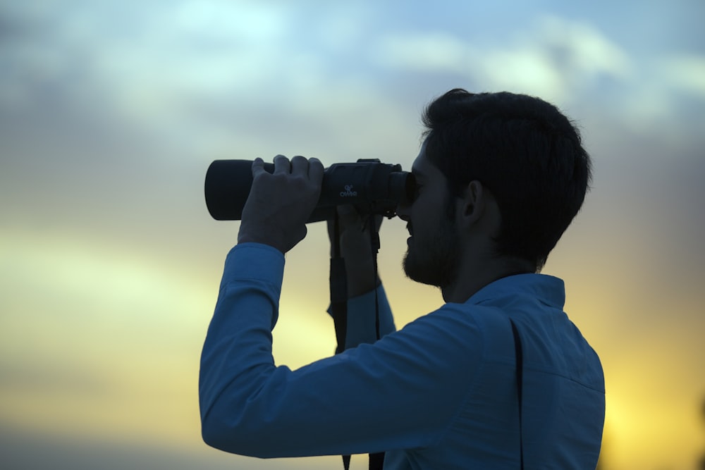 man holding telescope