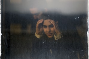 woman peaking on glass window panel