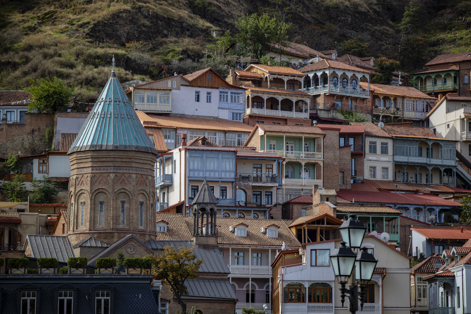 Tiled rooftops and houses on the hills of old Tbilisi