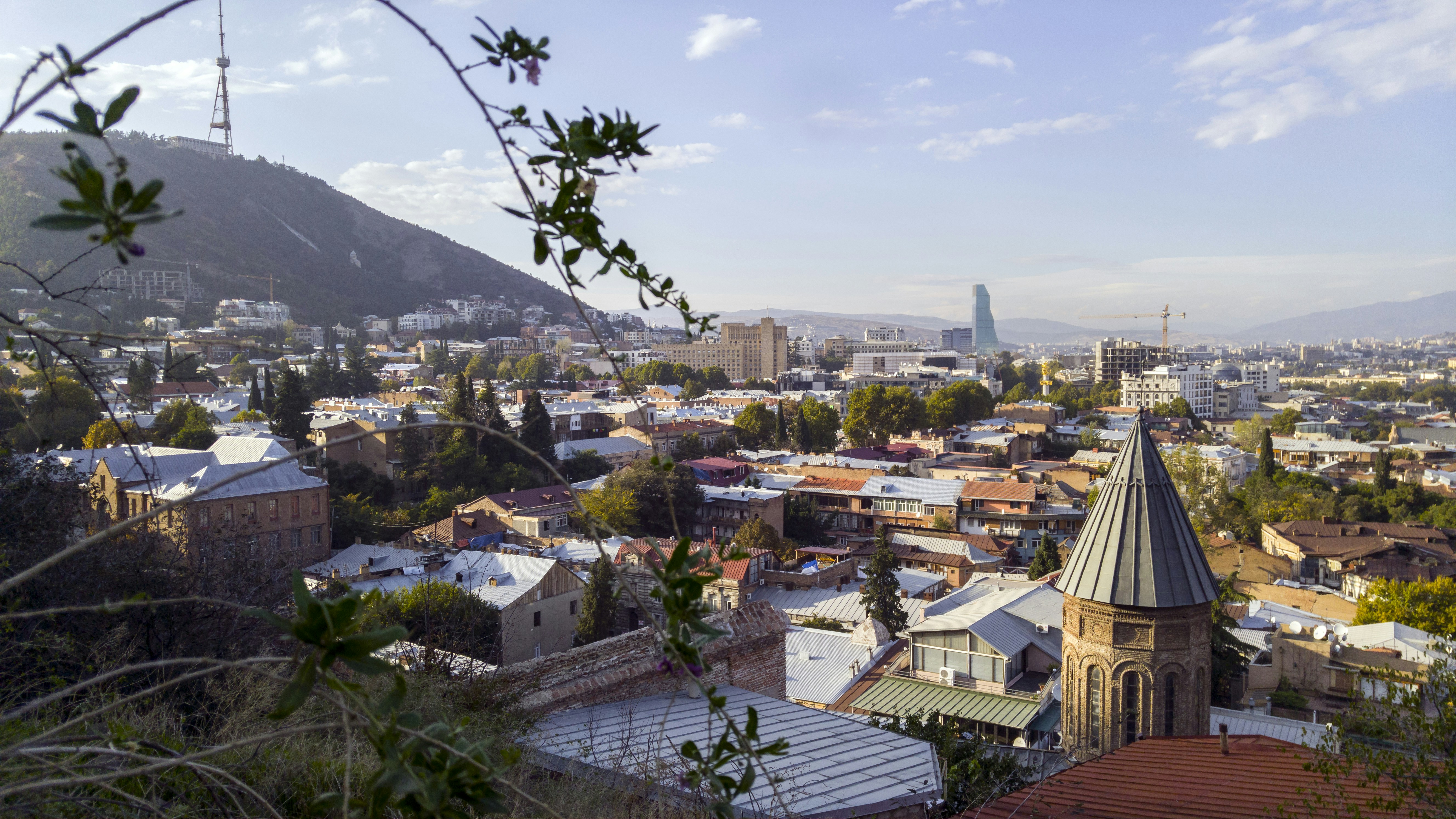 aerial photography of houses, Tbilisi in some countries also still known by its pre-1936 international designation Tiflis is the capital and the largest city of Georgia, lying on the banks of the Kura River with a population of approximately 1.5 million people. 