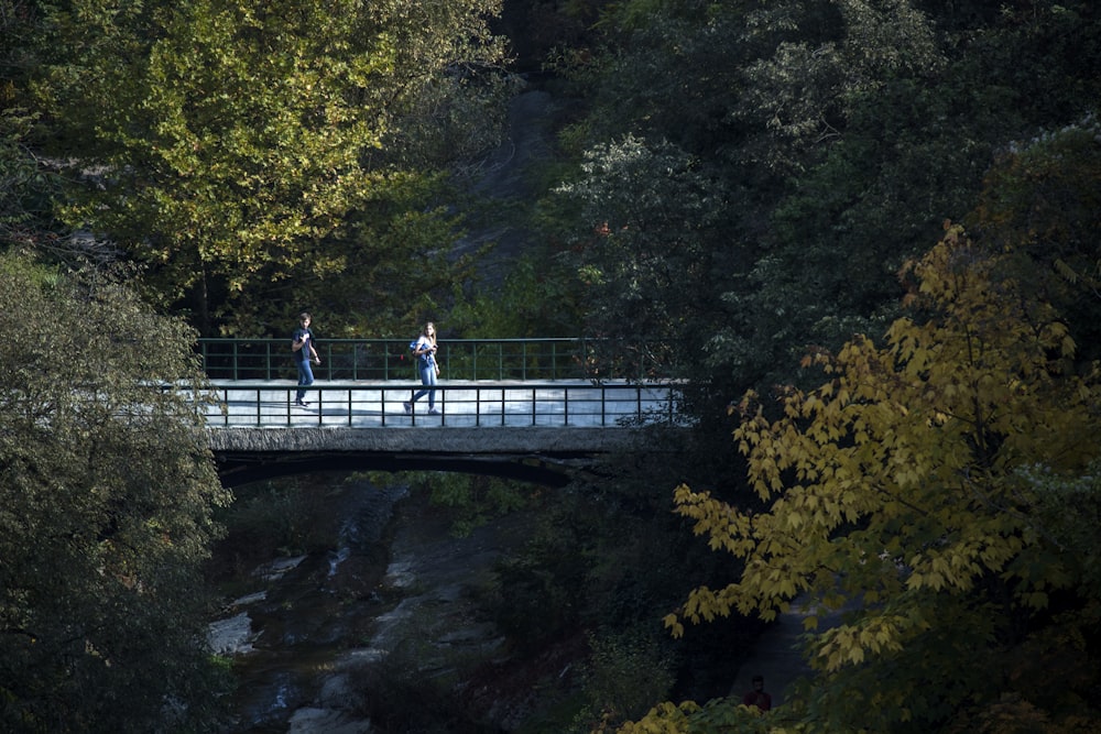 men crossing bridge