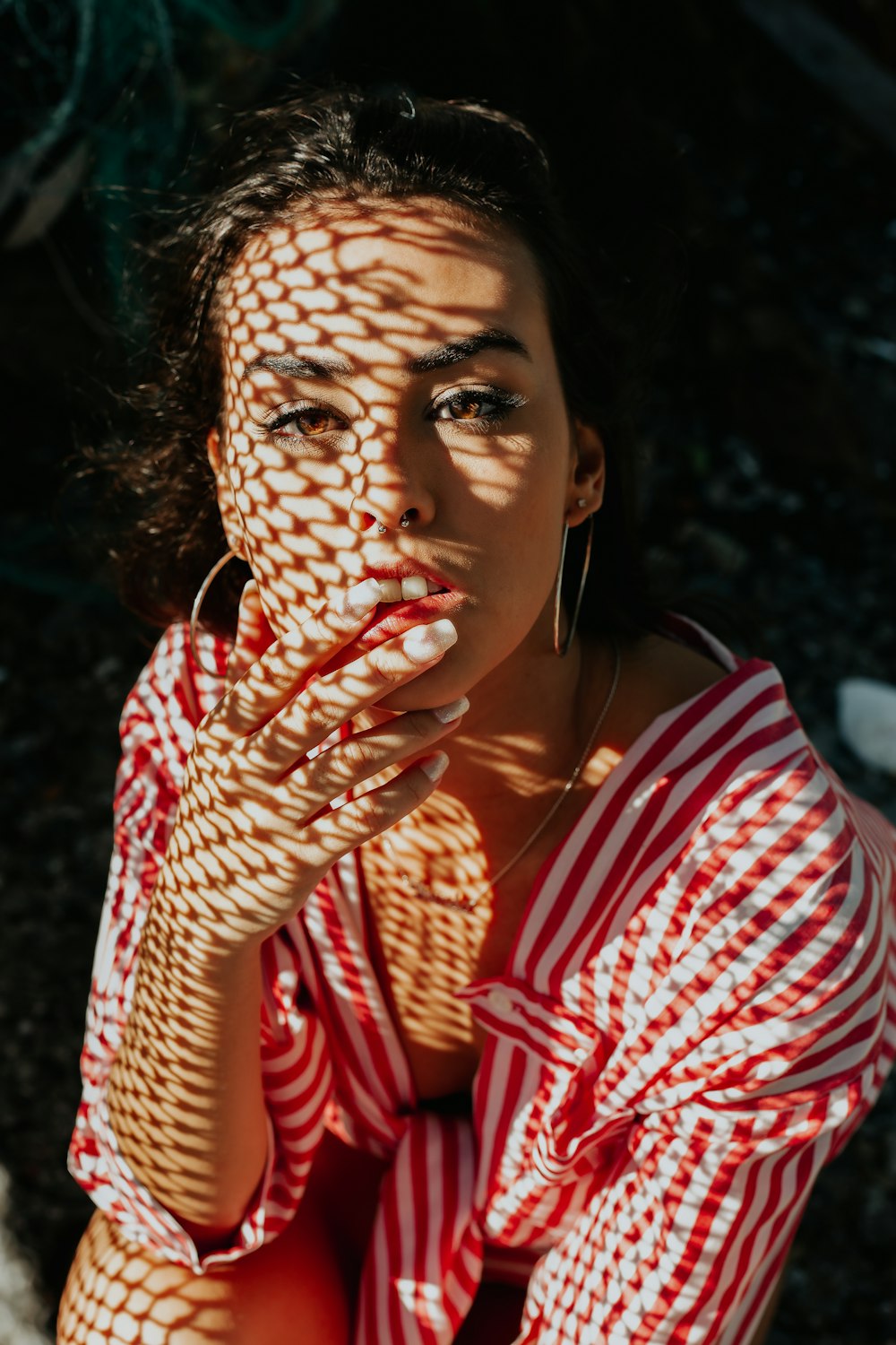 woman wearing red and white striped long-sleeved top