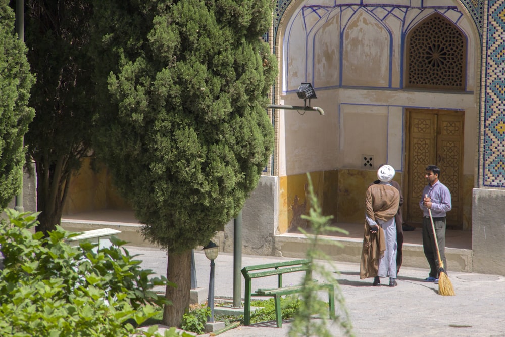 person wearing blue dress shirt near concrete building