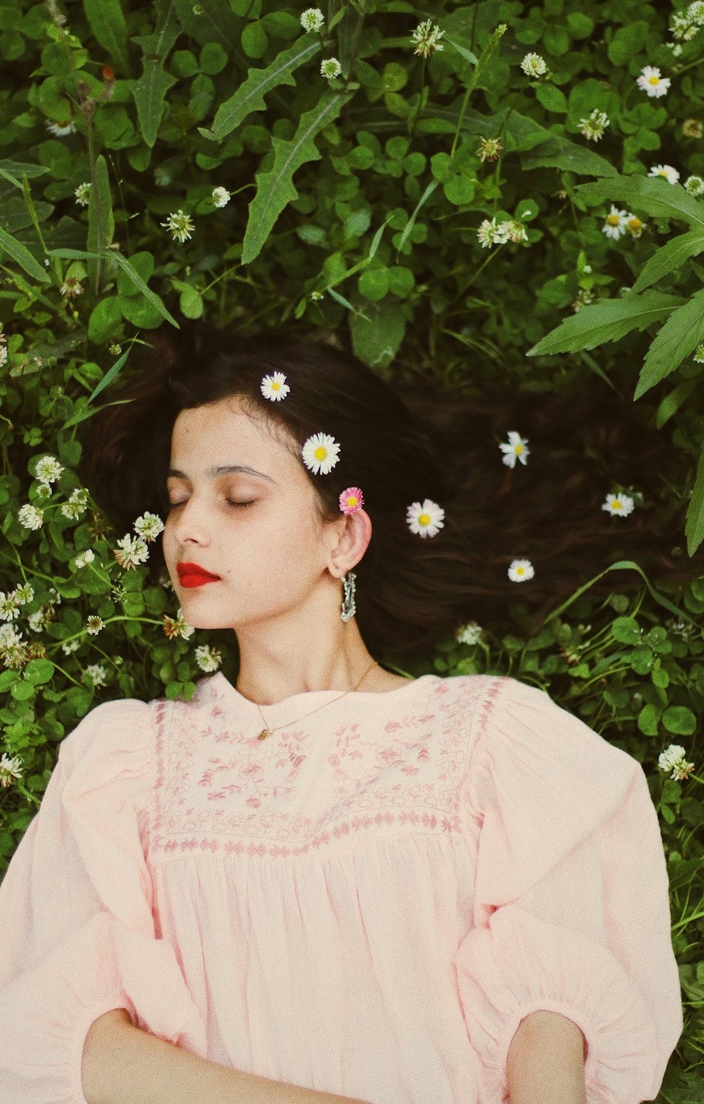 woman lying on plants