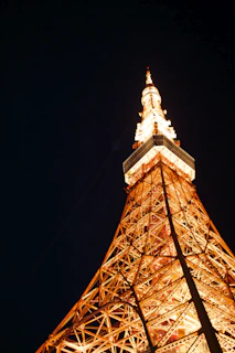Evening shot of the nearly completed Ikhwan Tower glowing softly under warm lighting.
