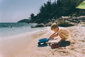 toddler playing at the beach