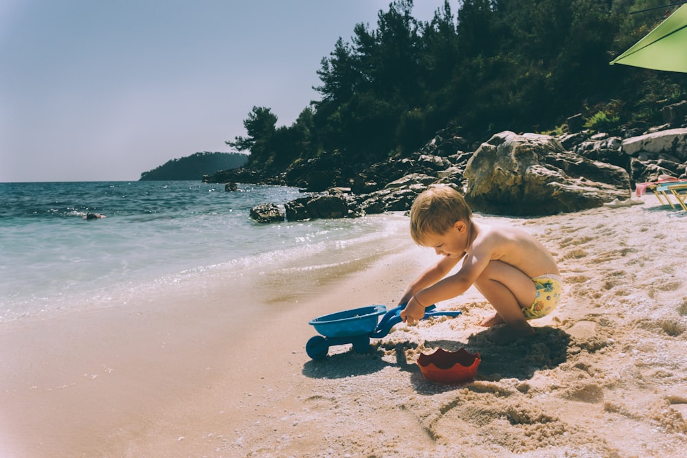 toddler playing at the beach