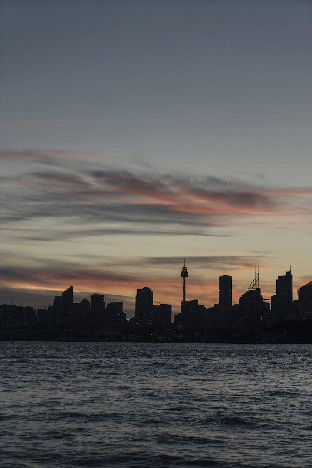 a large body of water with a city in the background