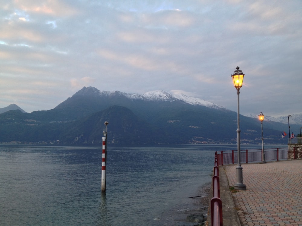 grey mountain near body of water during daytime