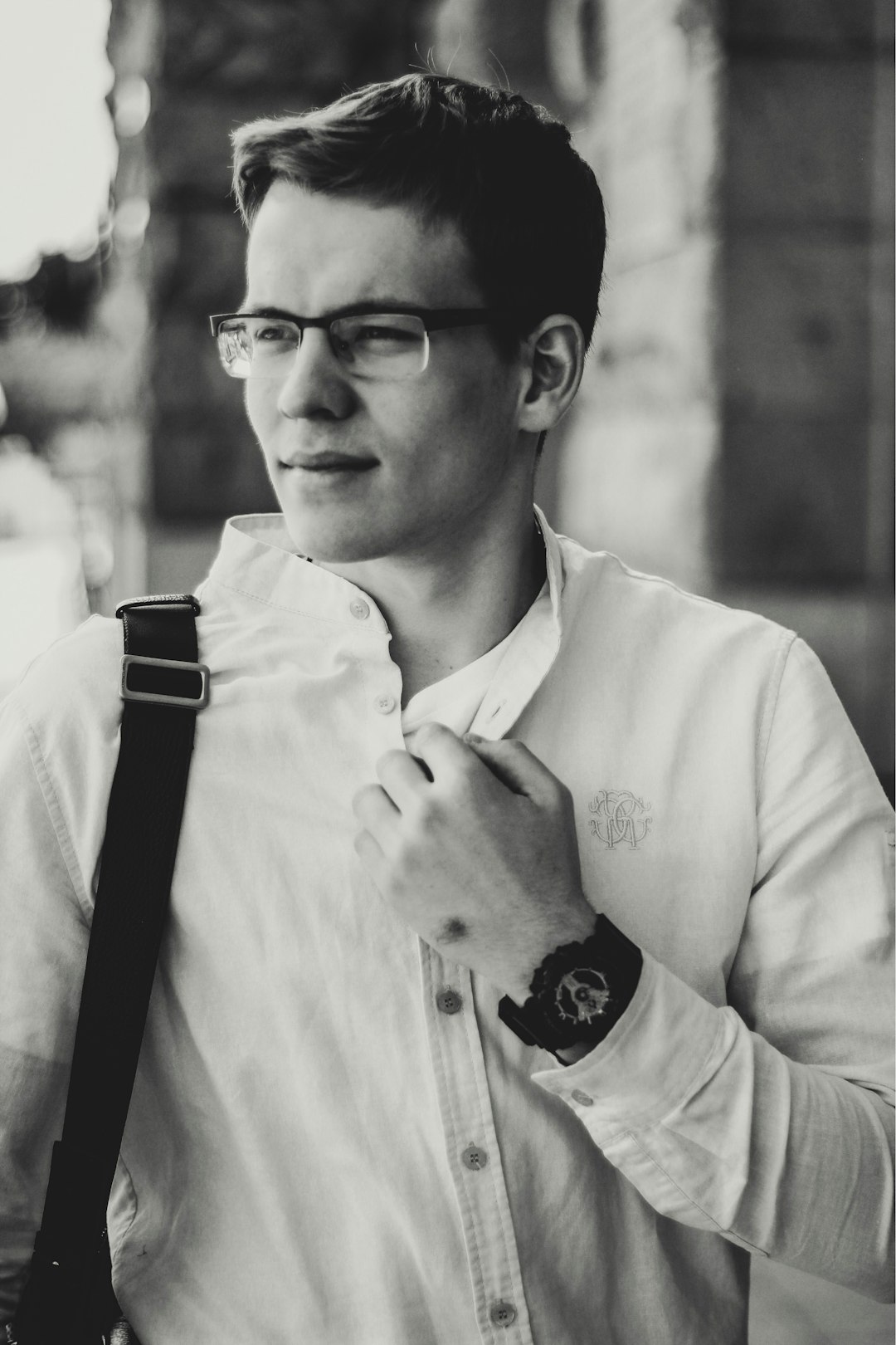 grayscale photo of man wearing white dress shirt and eyeglasses