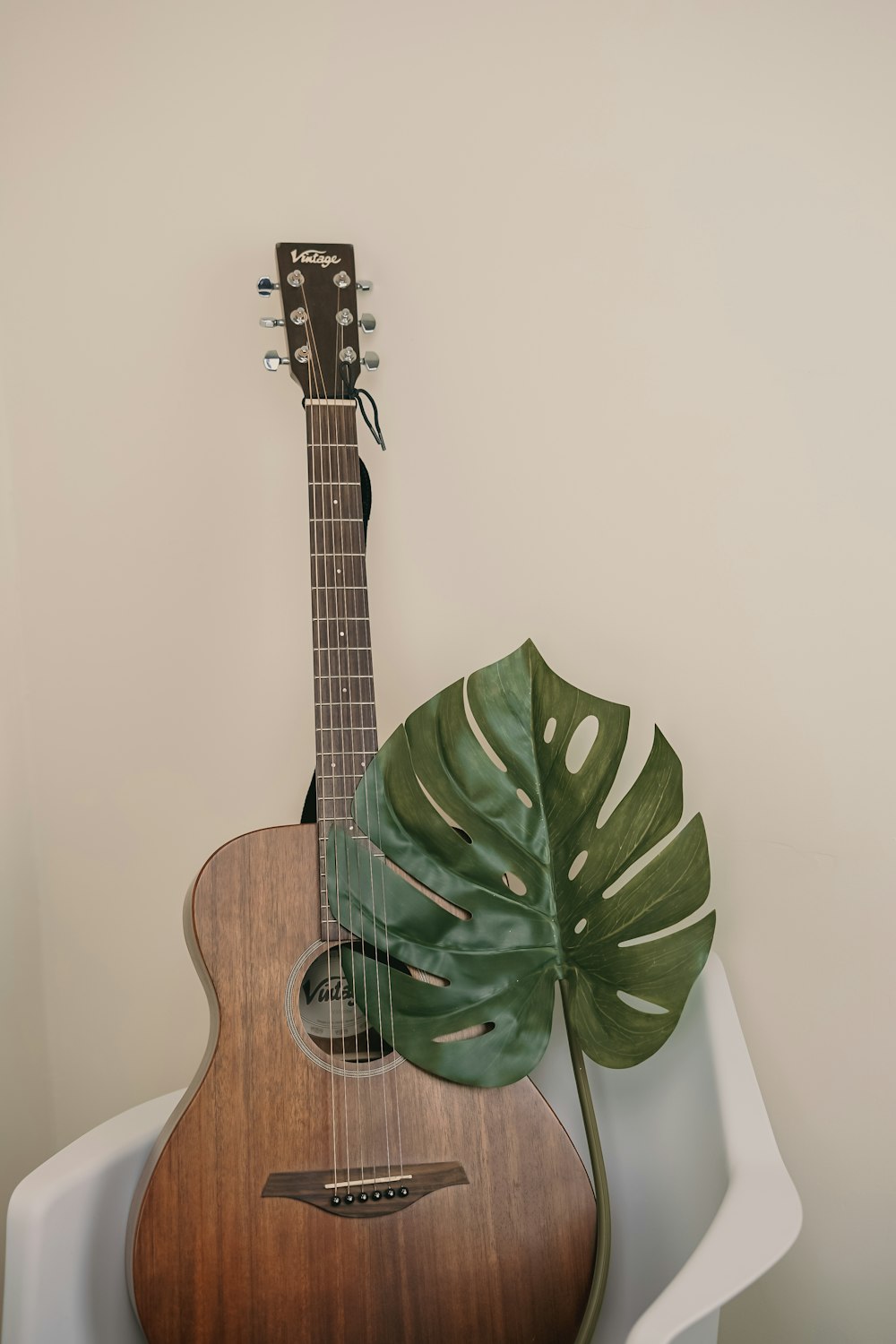 brown guitar on chair