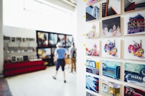 Colorful contemporary African paintings displayed on gallery walls during an exhibition.