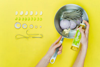 person holding gray frying pan