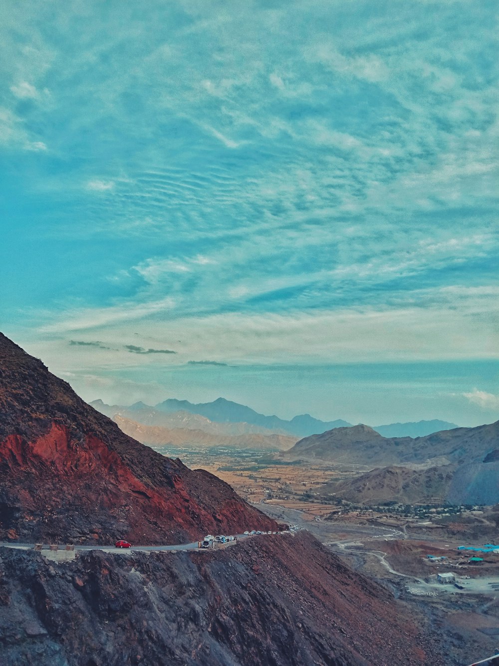 road on cliff under blue sky