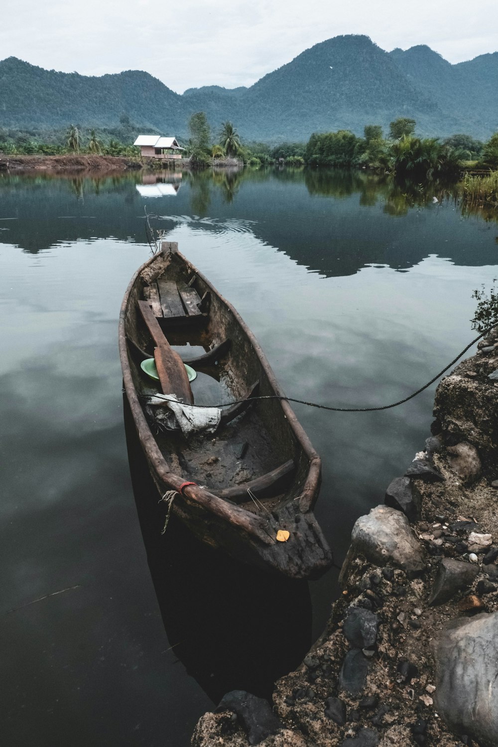 brown canoe with no people near rock formation