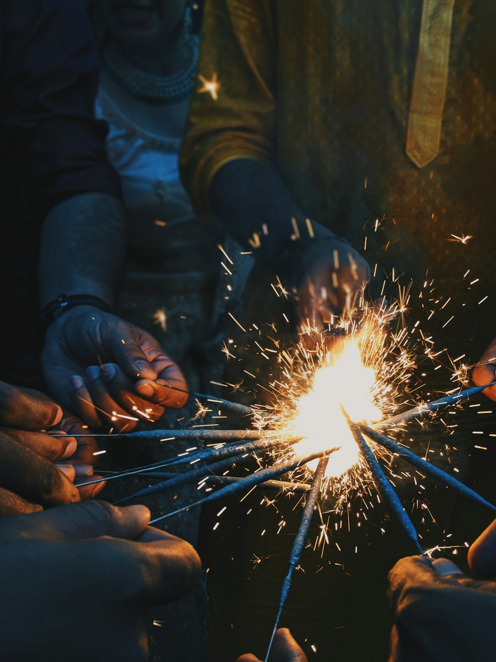 people holding lighted sparklers