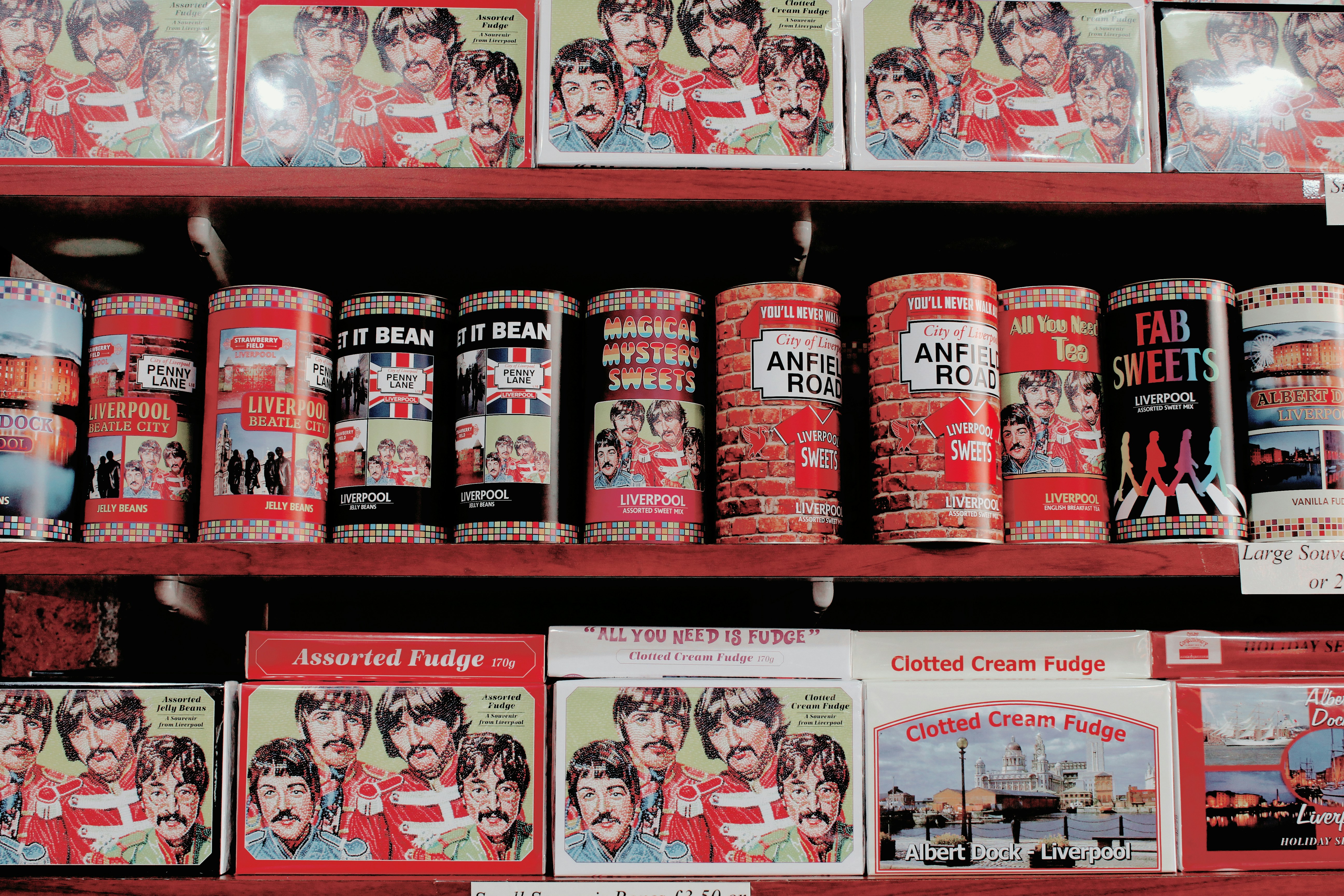 assorted cans and boxes on red shelves