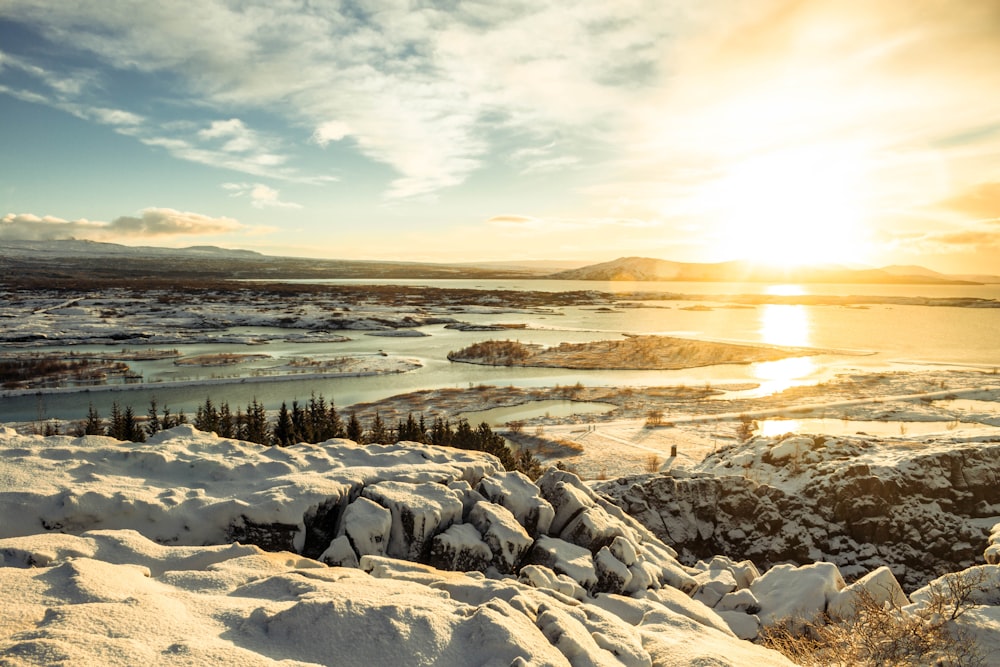 snow and tree covered islands during golden hour