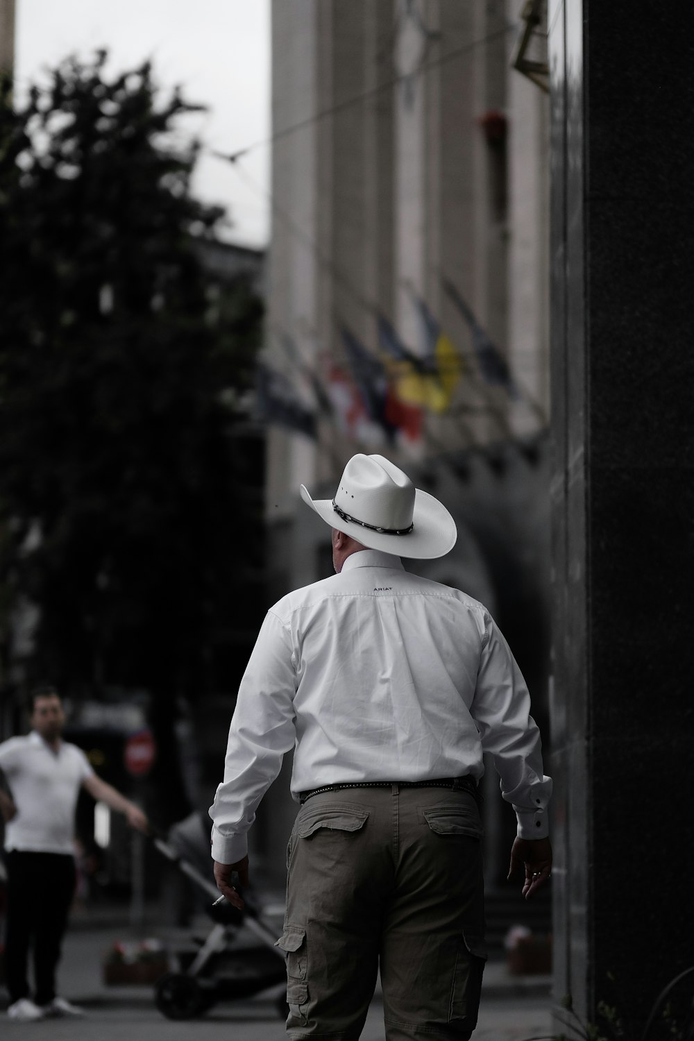 man in white cowboy hat and dress shirt