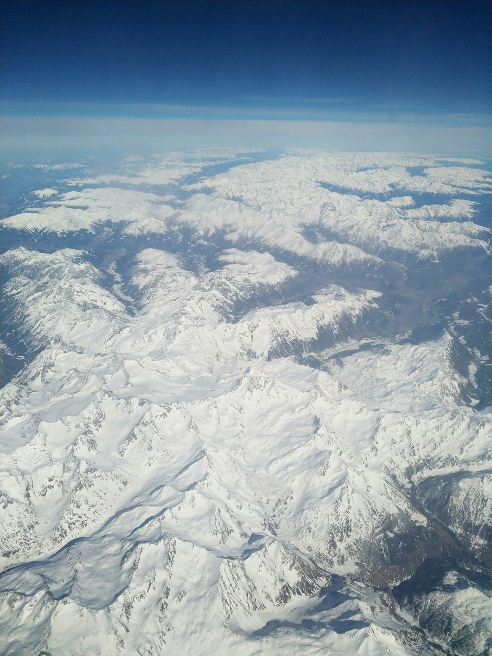 aerial view of snow covered mountain ranges