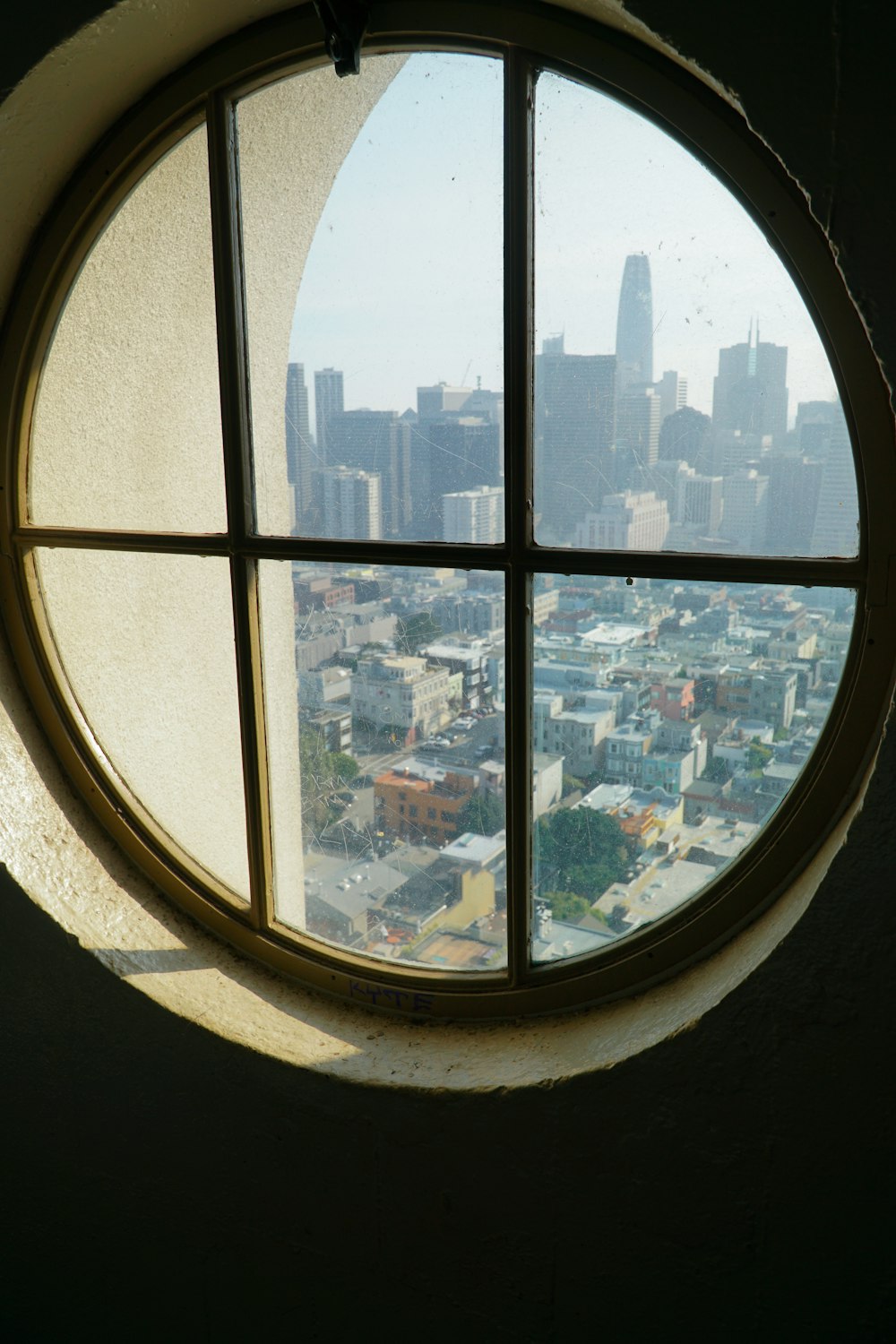 closed window viewing city with high-rise buildings