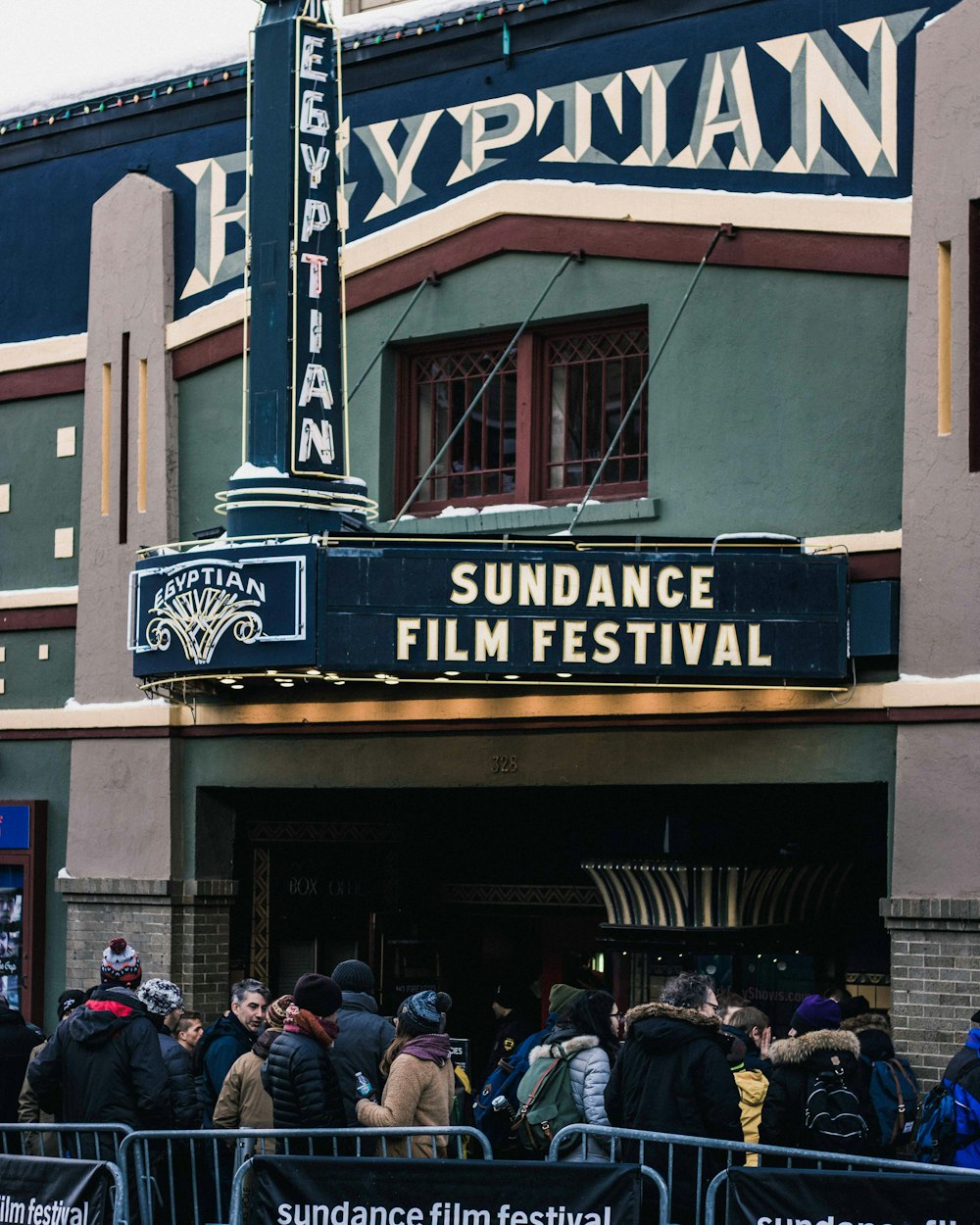 people in queue in front of theater