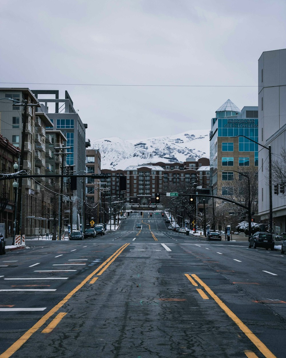 road between buildings under gray sky