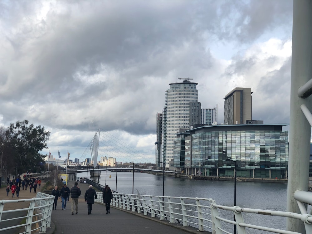 people in walkway by the river