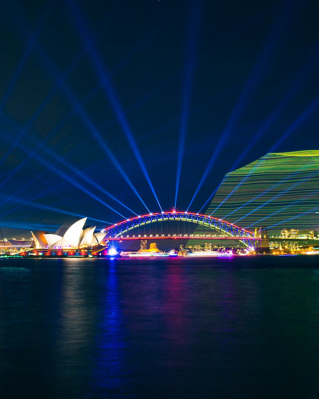 multicolored lights in bridge near Sydney Opera House
