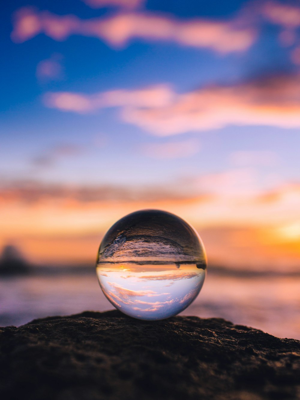 clear glass ball across clouds