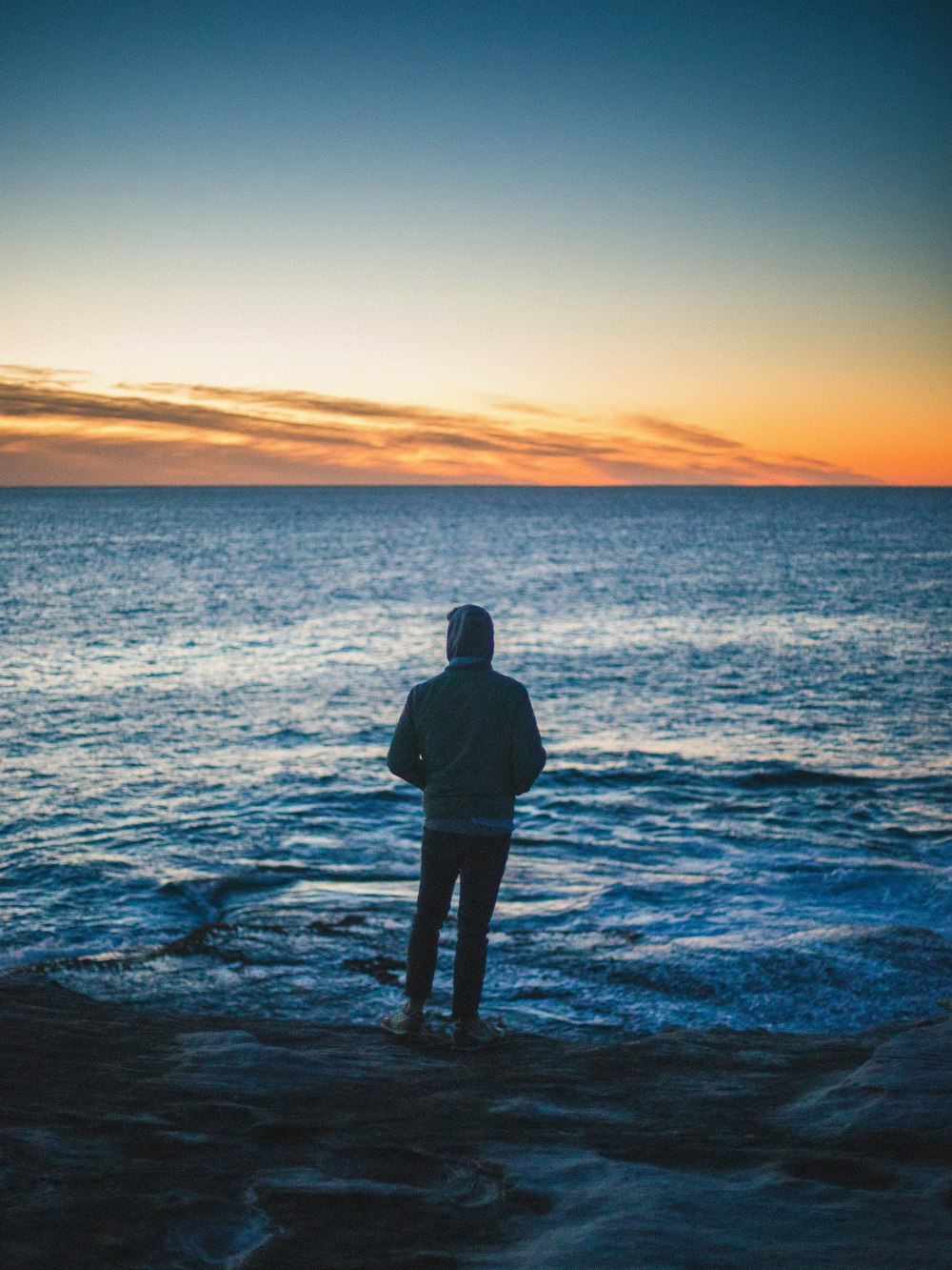 man standing in front of body of water